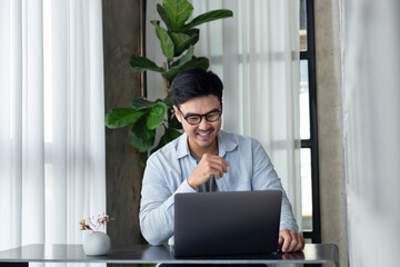 asian man work using computer hand typing laptop keyboard contact us.student study learning...