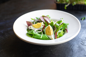 egg vegetables salad green leaves mix spinach, arugula, lettuce on the table wholesome food healthy meal snack copy space food background rustic. top view keto or paleo diet veggie or vegetarian