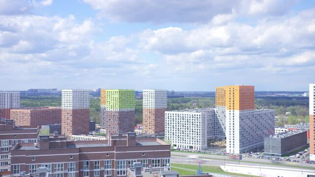 Clouds over the modern urban residential distict and green park area. Time lapse video shot on Red
