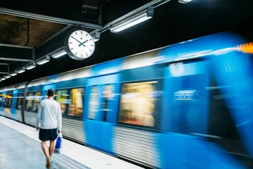 Tuinposter Stockholm, Sweden. Modern Illuminated Metro Underground Subway Station In Blue And Gray Colors With Moving Train © Grigory Bruev