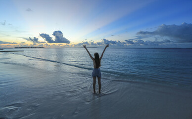 Fototapeta premium teenage girl in a swimsuit on the shore of a tropical island