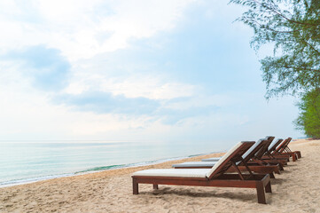 Wooden beach bed or sunbed beach on beautiful beach with turquoise ocean and blue sky, no people,...