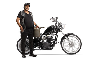 Fototapeta na wymiar Full length portrait of a biker with a chopper motorbike holding a gas canister