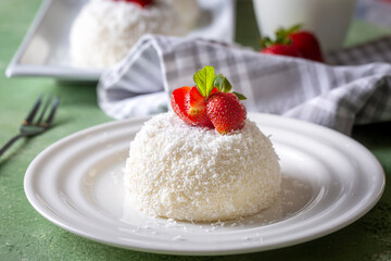 Delicious milk dessert; cup dessert with coconut and strawberry (Turkish name; fincan tatlisi