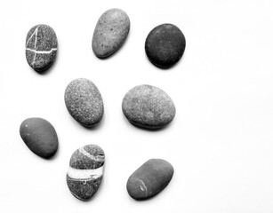 Set of various black-white and gray sea stones.  Isolated over white background.  Flat lay, top view.