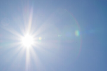Clear blue sky, sun, beautiful sunbeams and glare