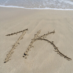 1k thanks to 1000 follower on social media handwriting in sand on the beach
