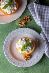 Celery salad with apple and walnuts served in orange cups.