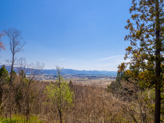 Overlooking bald forest, town and mountains (Inawashiro, Fukushima, Japan)