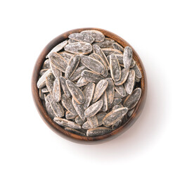 Top view of salted sunflower seeds in wooden bowl