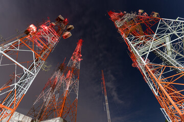 Tower of communication with antennas at night time.