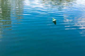 White paper skiffs float on water