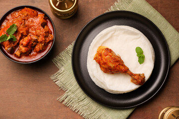 Rice pathiri  Pathir flat bread with spicy chicken curry, Kerala Tamil Nadu India SriLanka. Popular traditional South Indian breakfast dish of Malabar Muslims on Ramadan Ramzan, Eid festival Rice roti