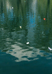 Many paper boats on the water