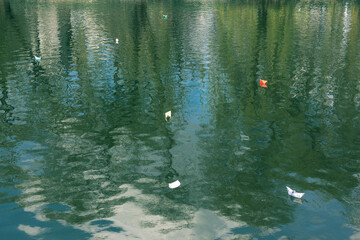 Many paper boats on the water