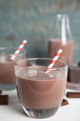 Delicious chocolate milk on white wooden table