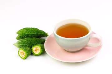 Bitter gourd or bitter melon tea in ceramic cup isolated on white background. Scientific name is Momordica charantia. As a whole food and herbs for treating diseases.