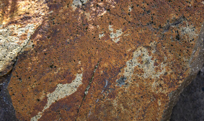 Brown andesite stone surface texture. Brown-grey rock with  cracks and cavities. Template for background