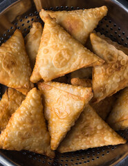 samosa or samusa, deep fried, triangular shaped pastry filled with spicy potato, popular snack in south asia