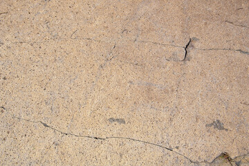 Brown andesite stone surface texture. Brown-grey rock with  cracks and cavities. Template for background
