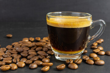glass cup with espresso and coffee beans