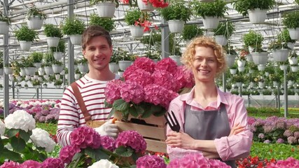 Portrait two happy workers who work together in a flower center. Concept i love my job
