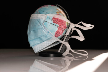 Fototapeta na wymiar World globe wearing surgical mask to fight corona virus covid 19 pandemic