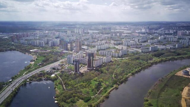Amazing high angle top drone view on Strogino and Shchukino	district which are situated in beautiful green river park.
