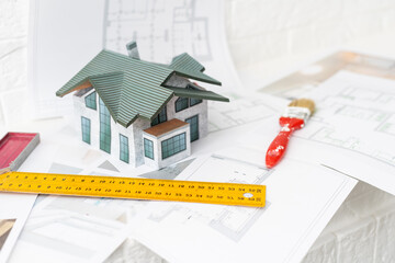 building house on blueprints with worker - construction project