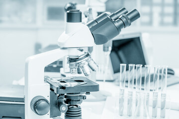 Toned photo of scientific trinocular microscope with camera in science laboratory