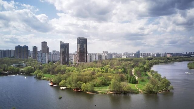 Amazing high angle top drone view on Strogino and Shchukino	district which are situated in beautiful green river park.
