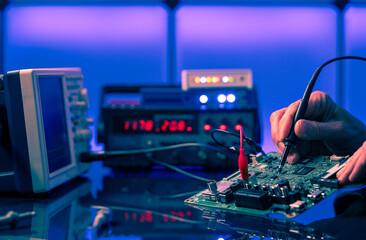 Debugging electronics device. PCB witch microcontroller in electronics laboratory