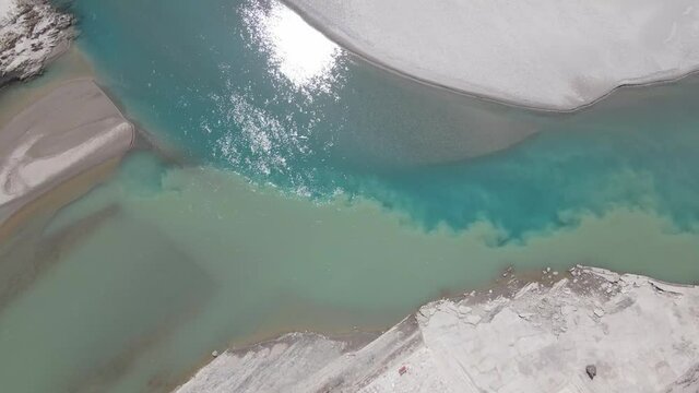 Aerial drone footage of a river meeting another river with different color at a sangam in Indus Valley in Ladakh.