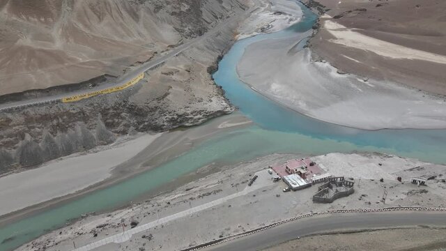 Aerial drone footage of a river meeting another river with different color at a sangam in Indus Valley in Ladakh.