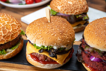 Tasty vegetarian cheeseburgers and hamburgers with round patties or burgers made from grains, vegetables and legumes