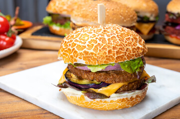 Tasty vegetarian cheeseburgers and hamburgers with round patties or burgers made from grains, vegetables and legumes