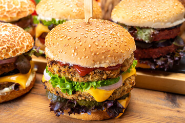 Tasty vegetarian cheeseburgers and hamburgers with round patties or burgers made from grains, vegetables and legumes