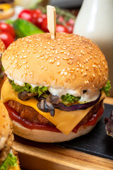 Tasty vegetarian cheeseburgers and hamburgers with round patties or burgers made from grains, vegetables and legumes