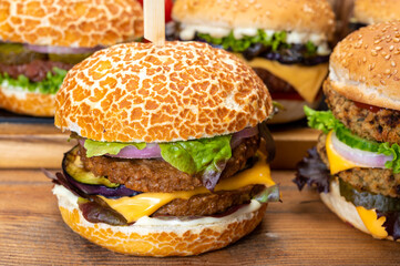 Tasty vegetarian cheeseburgers and hamburgers with round patties or burgers made from grains, vegetables and legumes
