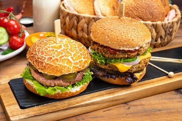 Tasty vegetarian cheeseburgers and hamburgers with round patties or burgers made from grains, vegetables and legumes
