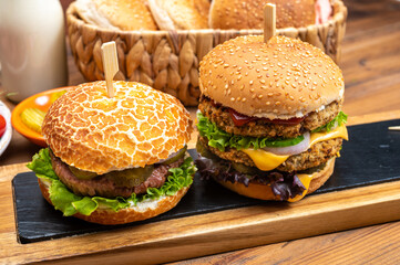Tasty vegetarian cheeseburgers and hamburgers with round patties or burgers made from grains, vegetables and legumes