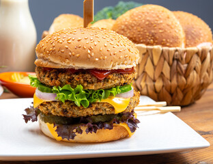 Tasty vegetarian cheeseburgers with round patties or burgers made from grains, vegetables and legumes