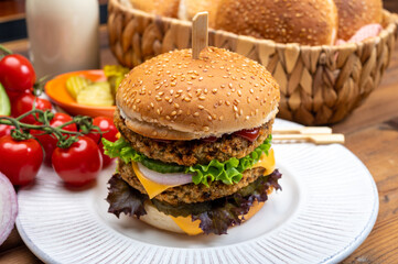 Tasty vegetarian cheeseburgers with round patties or burgers made from grains, vegetables and legumes