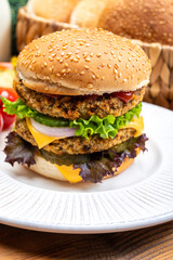Tasty vegetarian cheeseburgers with round patties or burgers made from grains, vegetables and legumes
