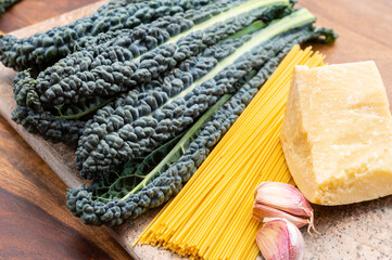 Cooking with black flat leaves of cavolo nero tuscan cabbage