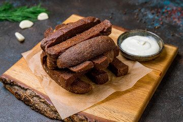 fried Garlic croutons with garlic sause on dark concrete table