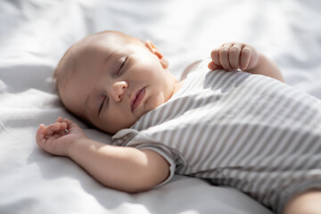 Closeup Shot Of Cute Lovely Newborn Baby Sleeping On Bed