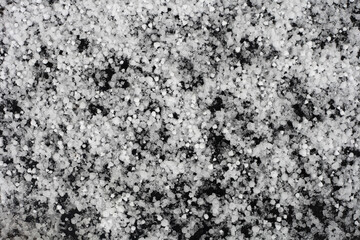 White ice floes hail against a black background