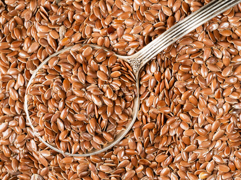top view of silver tablespoon in brown flax seeds