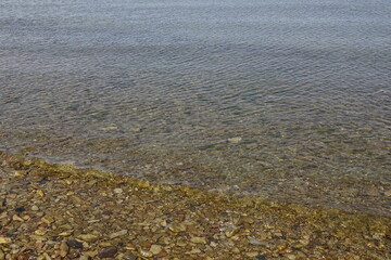 Clearwater in the sea and stones underwater during a sunny day, background, nature backdrop, wallpaper